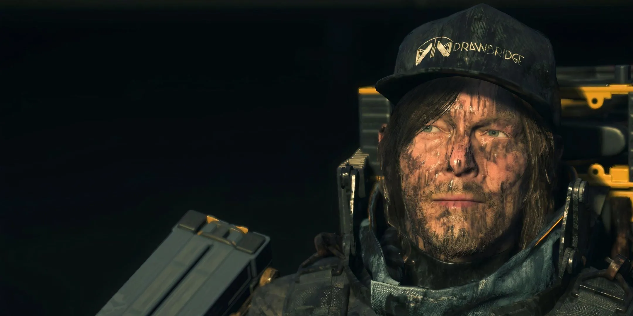 Sam bị bao phủ bởi nhựa đường, thể hiện một trong những thử thách môi trường trong Death Stranding 2
